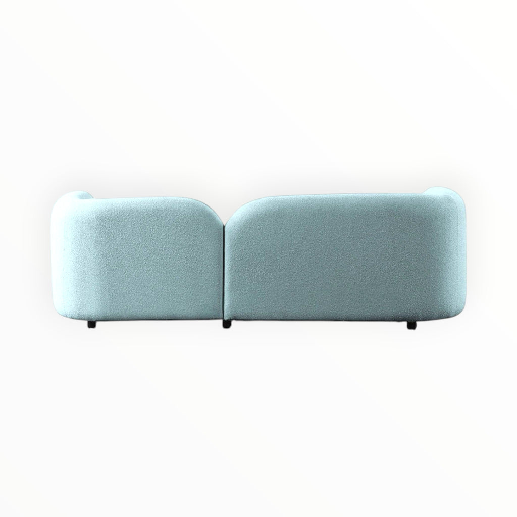 Light blue sofa back view on a white background