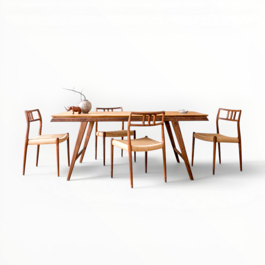 Wooden dining table with four chairs on a white background
