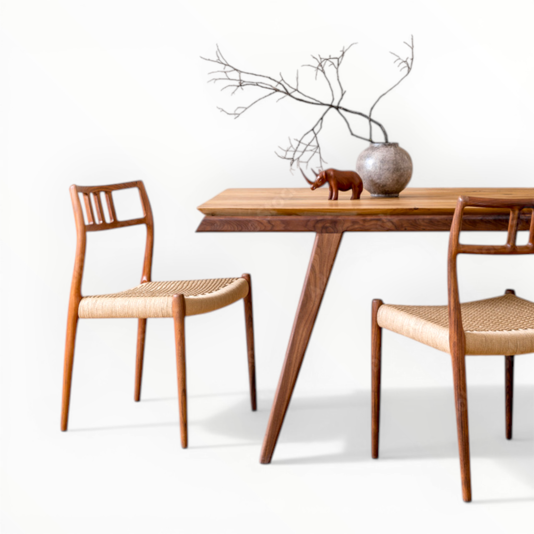 Dining table with two wooden chairs on a white background