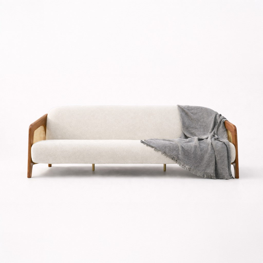 White sofa with wooden frame and gray blanket on a white background
