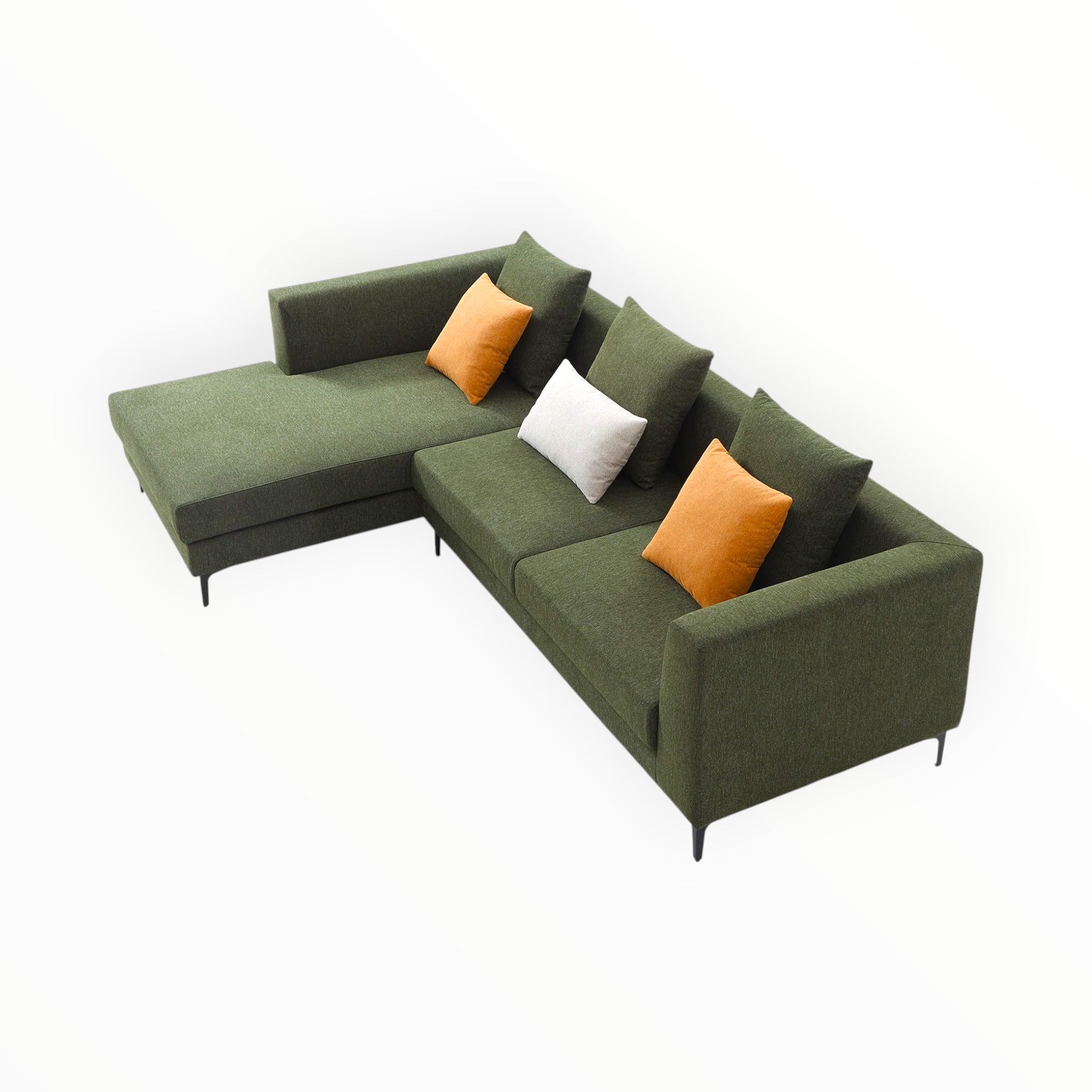 Green sectional sofa with orange and white cushions on a white background
