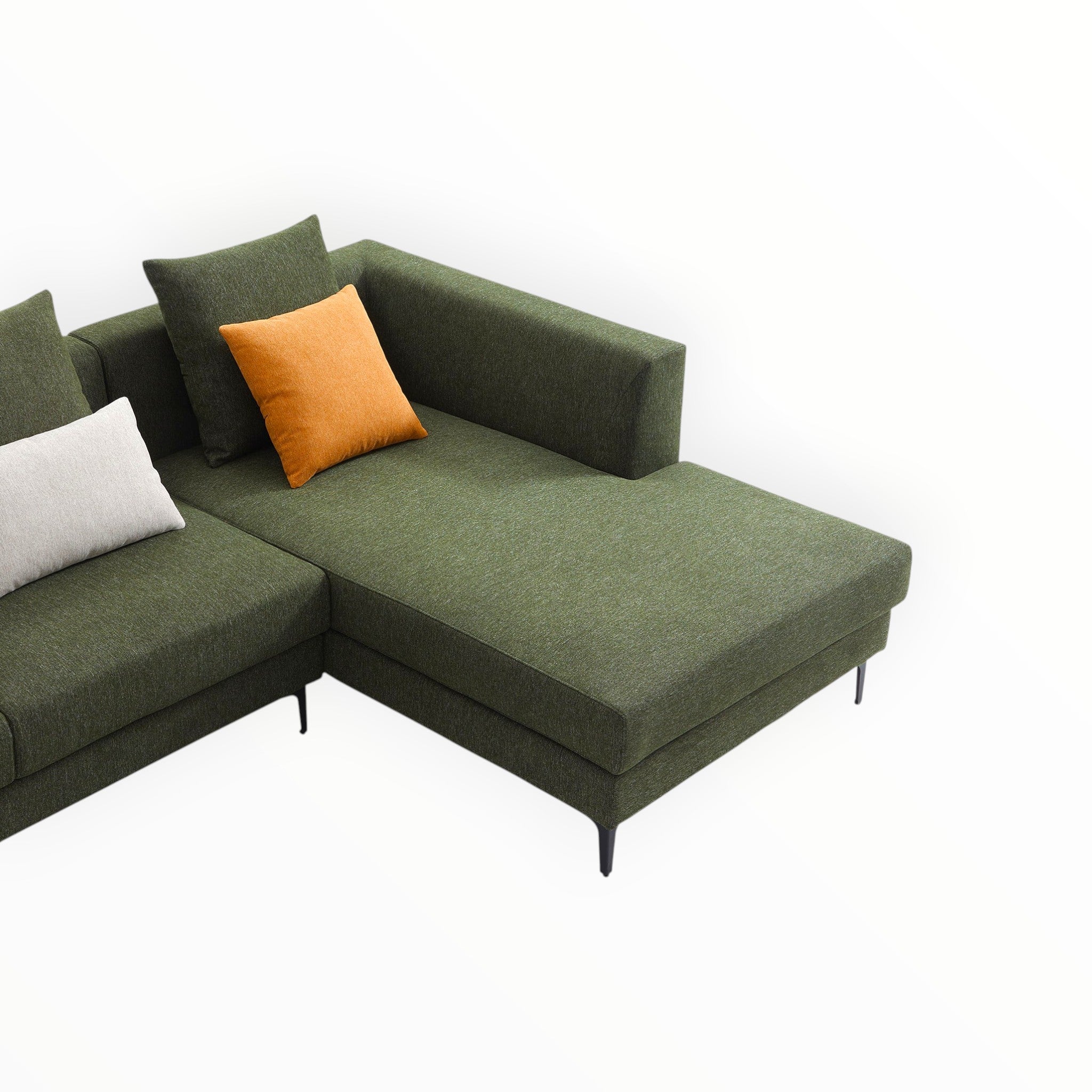 Green sectional sofa with orange and white cushions on a white background
