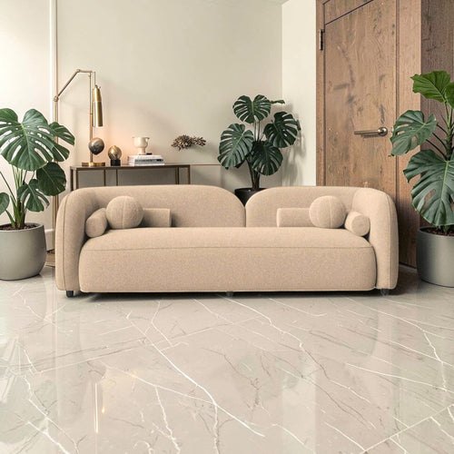 Beige sofa in a modern living room with plants and decor.