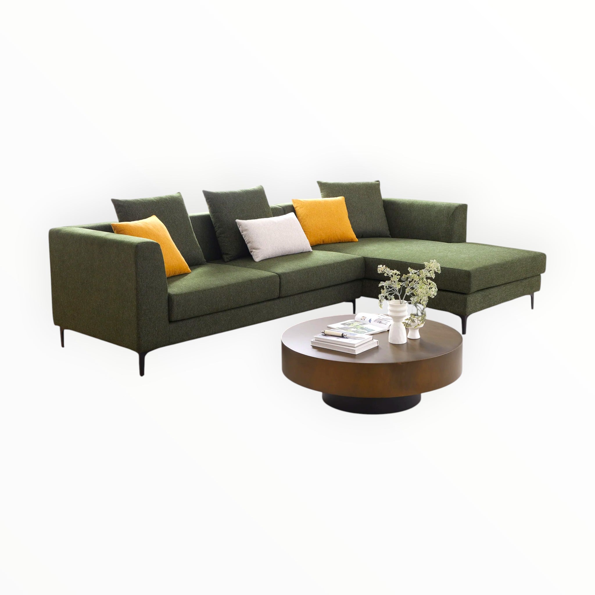 Green sectional sofa with colorful cushions and a wooden coffee table on a white background