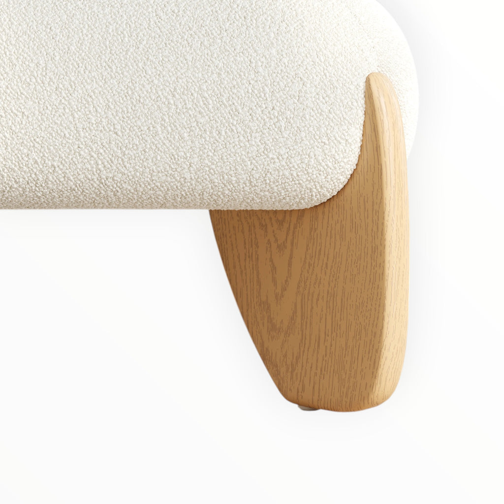 Close-up of a white textured cushion on a wooden bench leg against a white background