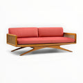 Sofa with red cushions and wooden frame on a white background