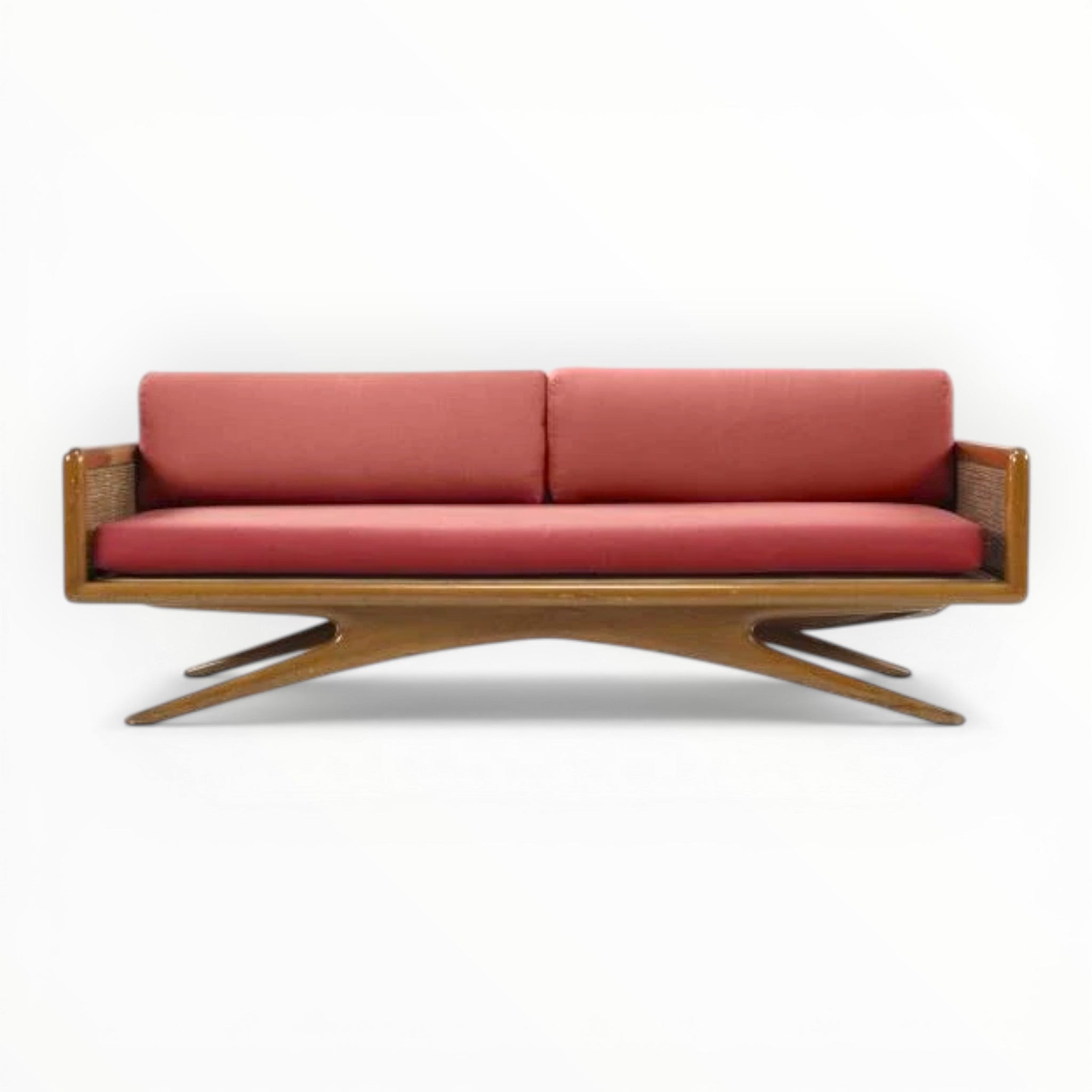 Wooden sofa with red cushions on a white background