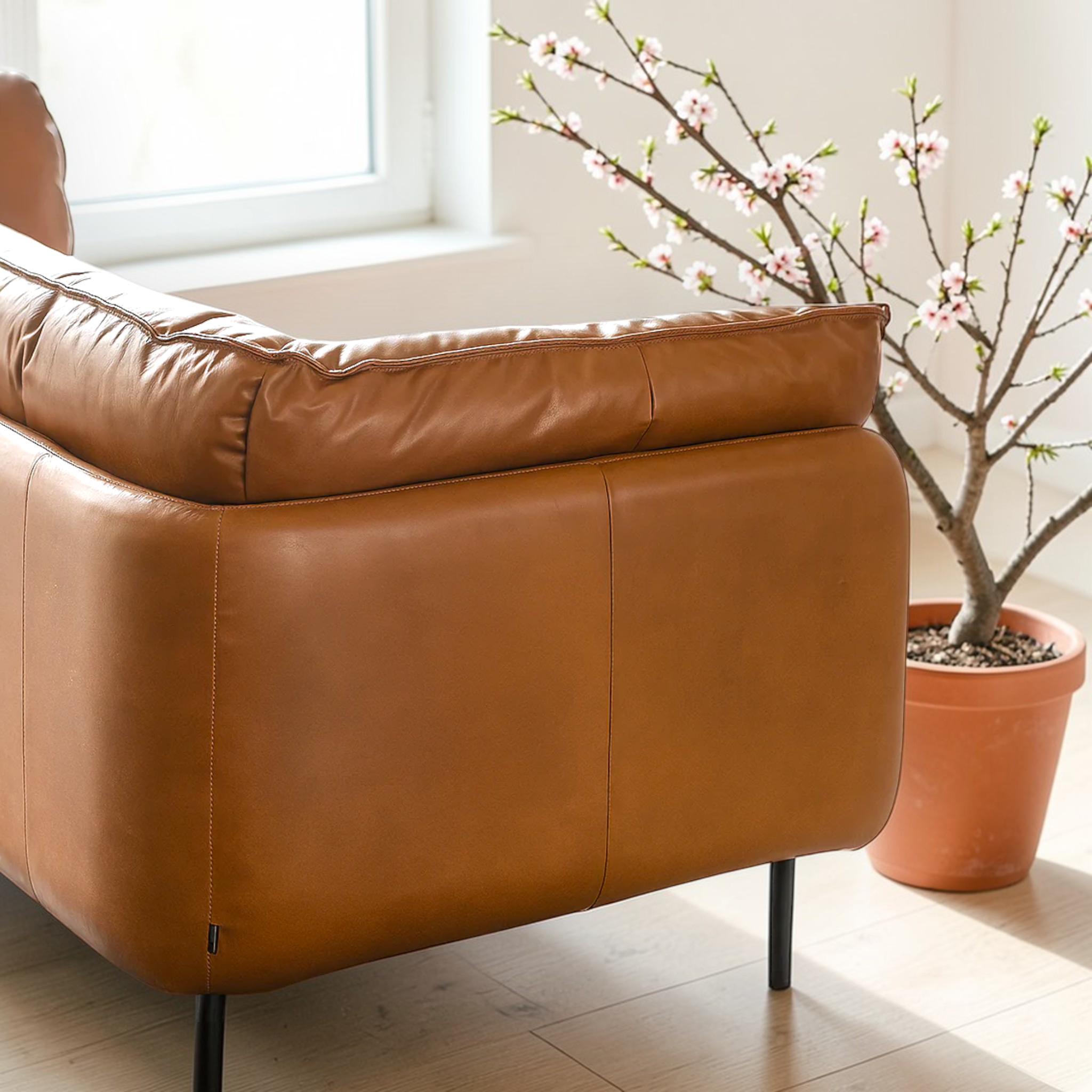 Brown leather armchair in a room with a potted plant