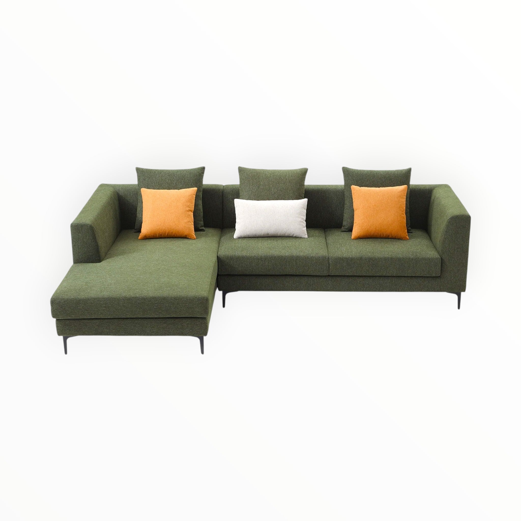 Green sectional sofa with orange and white cushions on a white background