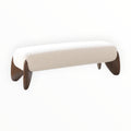 Beige bench with curved legs on a white background