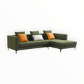 Green sectional sofa with colorful cushions on a white background