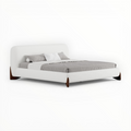 White bed with gray bedding on a white background