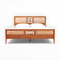 Wooden bed with wicker accents on a white background