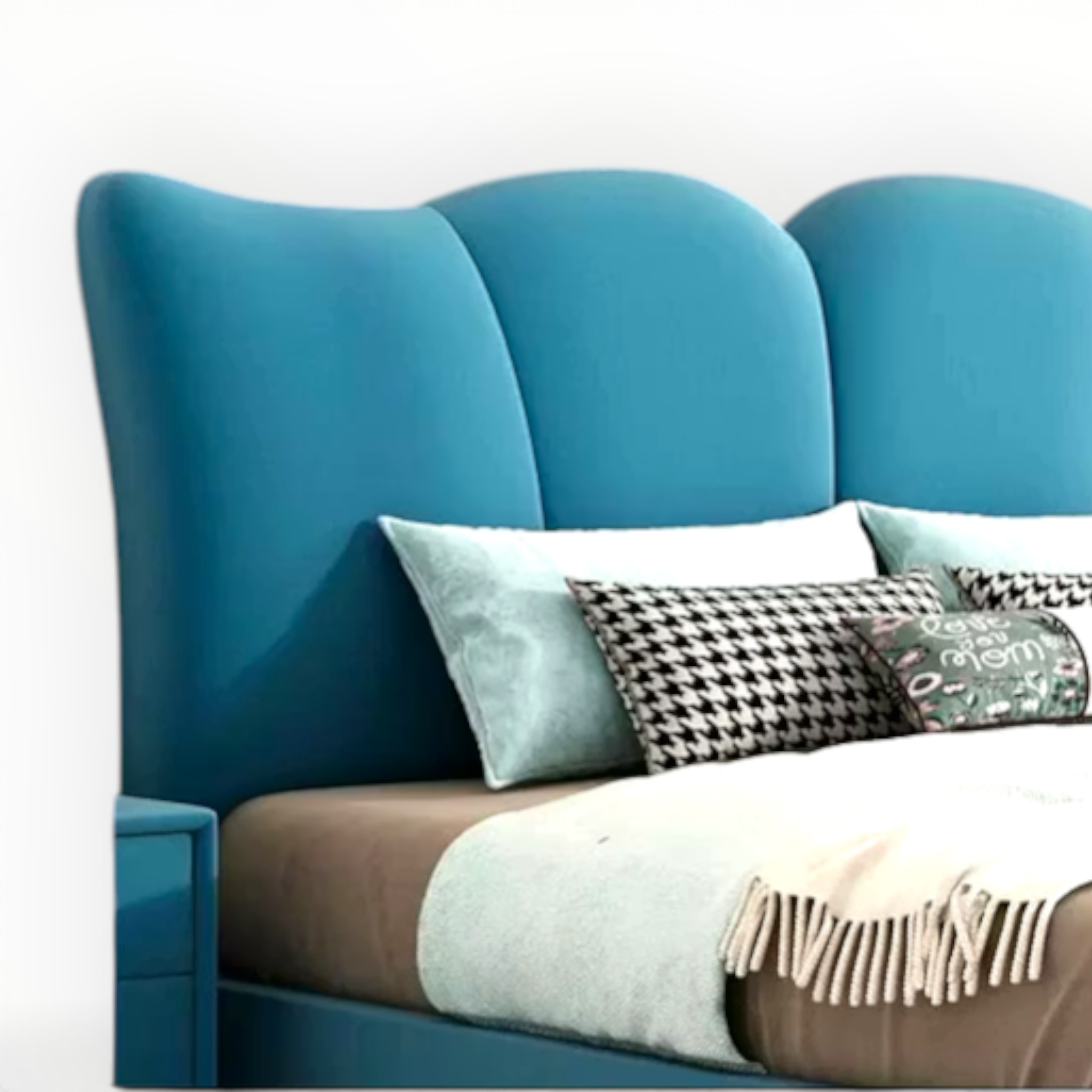 Blue upholstered headboard with decorative pillows on a bed against a white wall.