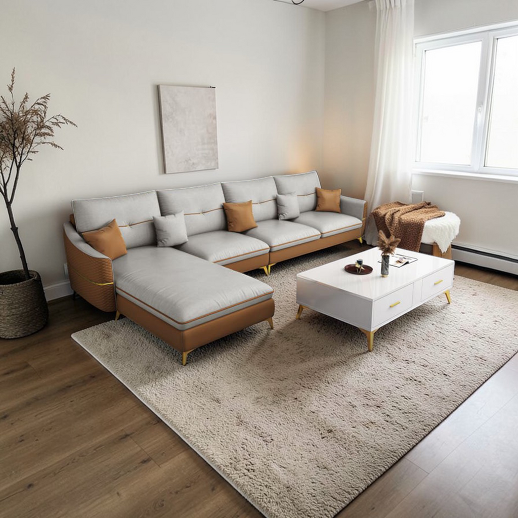 Modern living room with a sectional sofa, coffee table, and decorative elements.