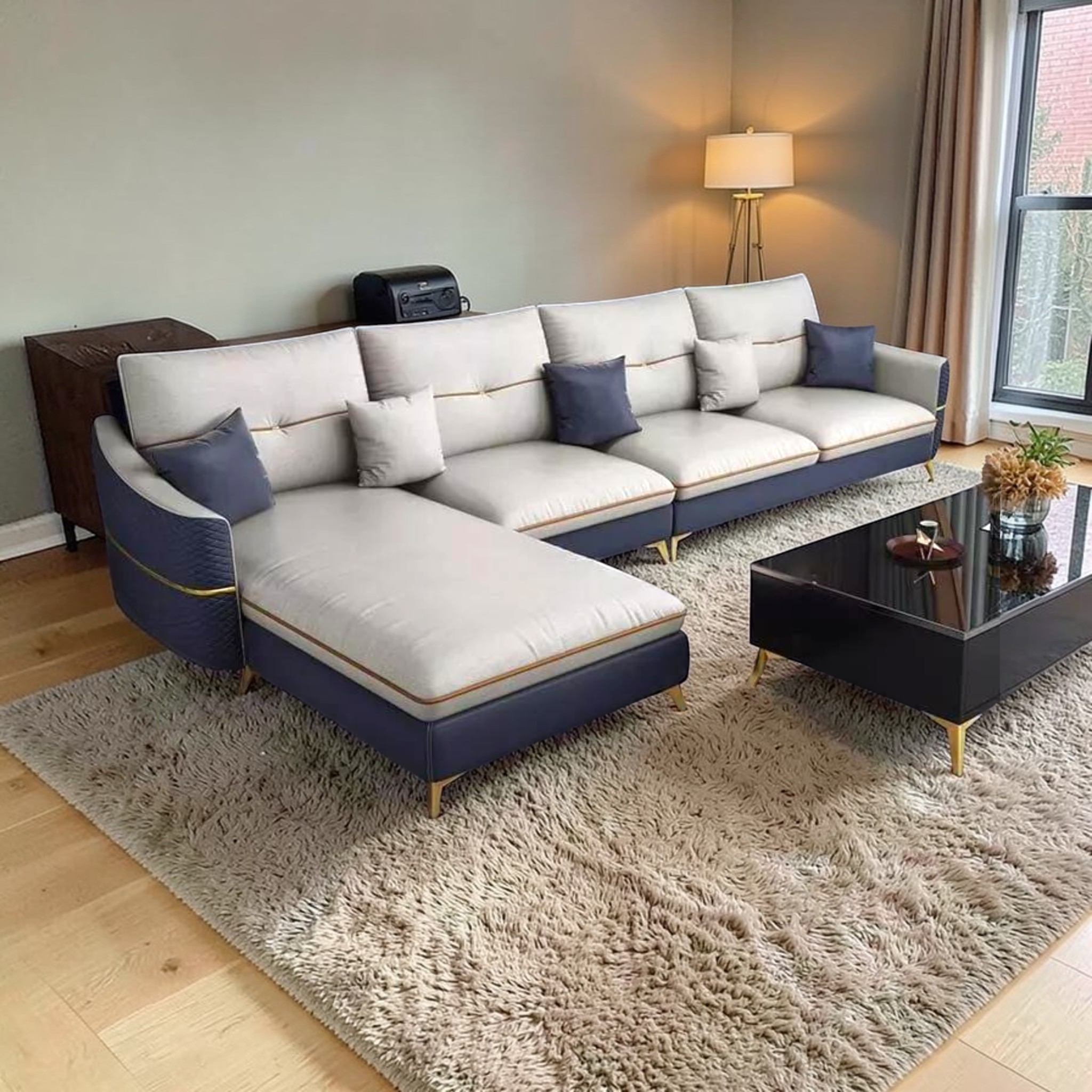 Modern living room with a sectional sofa, coffee table, and decorative items.