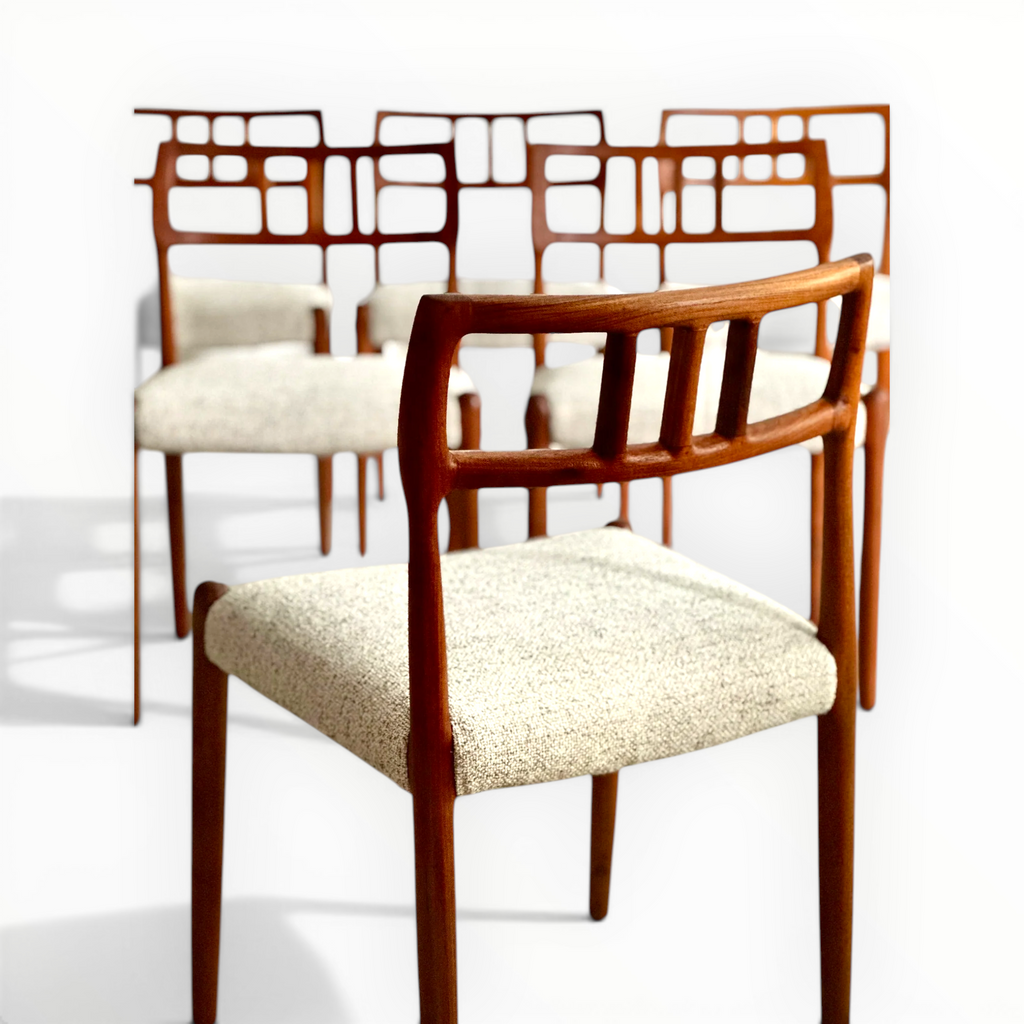 Wooden chairs with beige cushioned seats on a white background