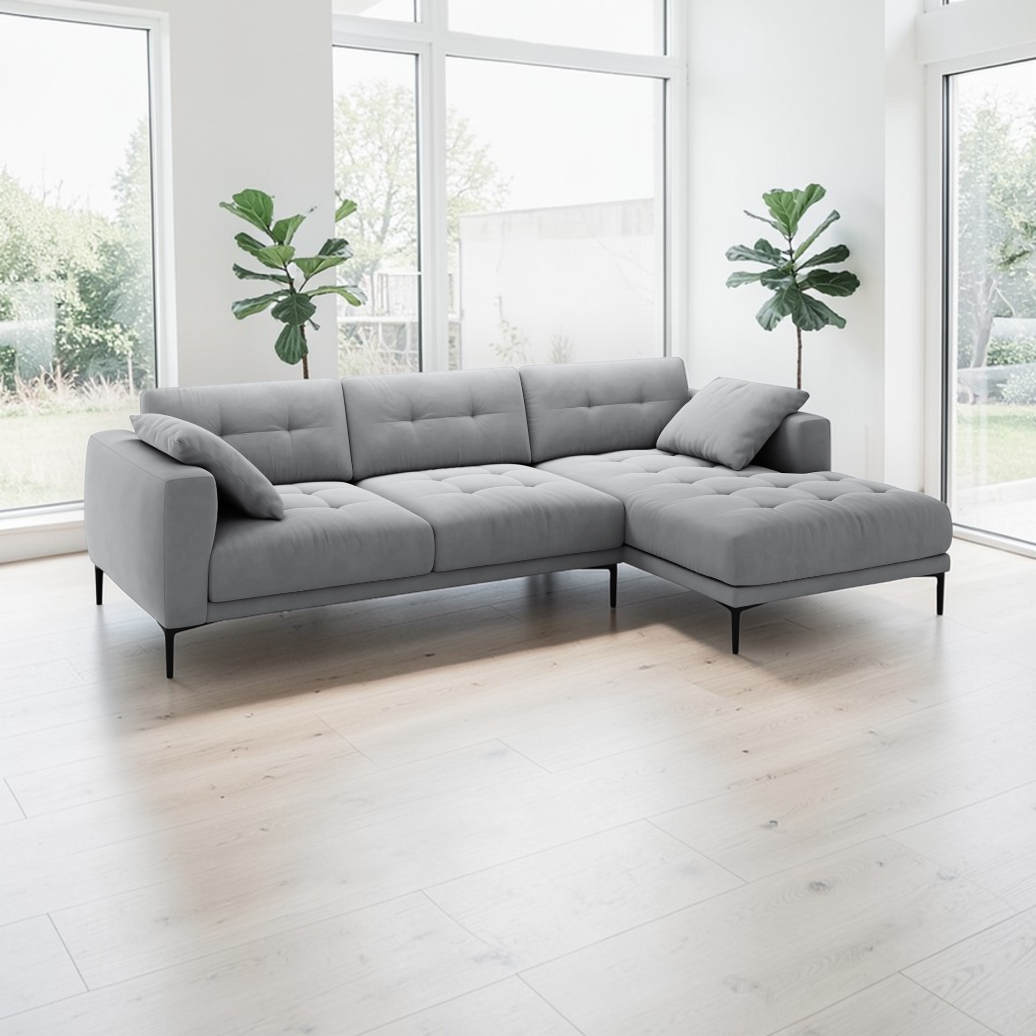 Gray sectional sofa in a bright room with large windows and plants.