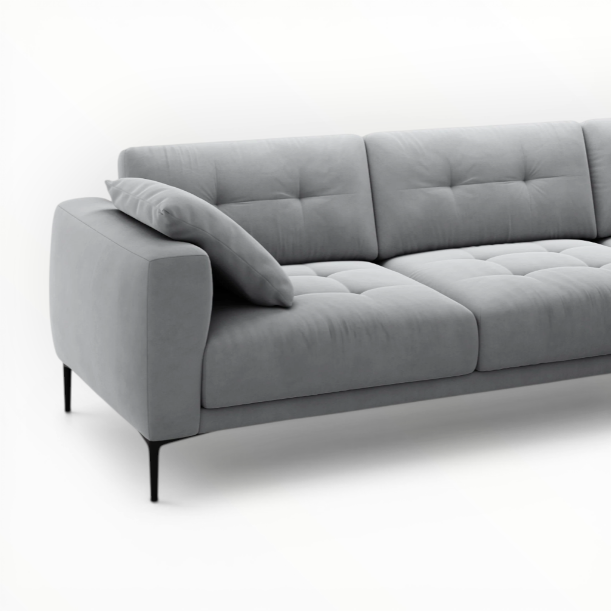 Gray sofa with tufted backrest on a white background