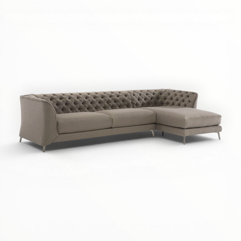 Beige sectional sofa with tufted backrest on a white background