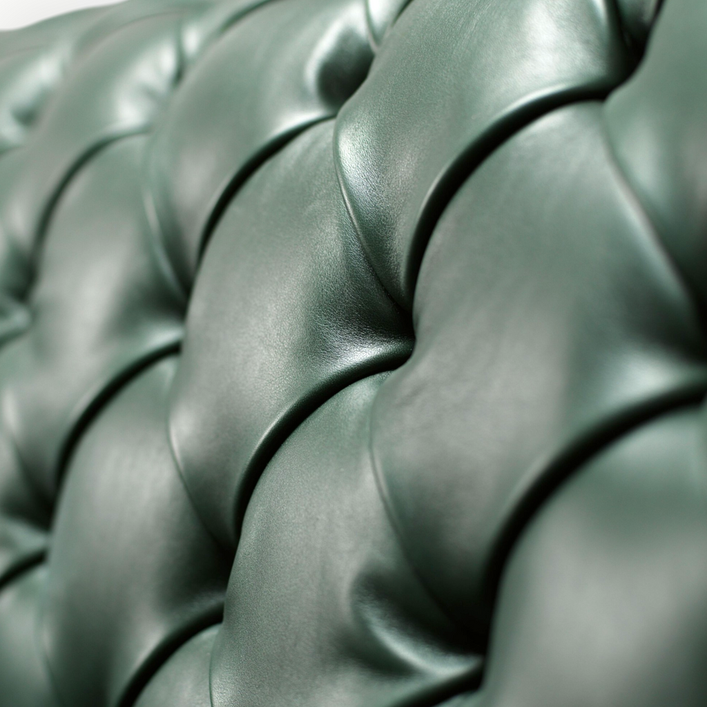 Close-up of a green tufted leather surface