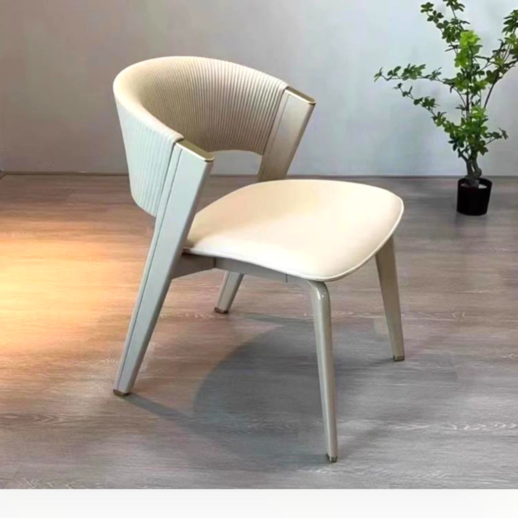Modern chair with a plant in the background on a wooden floor