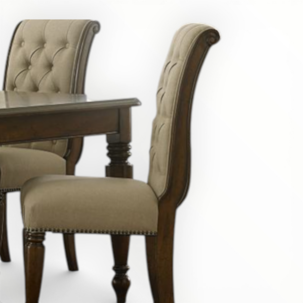 Dining table with two upholstered chairs on a white background