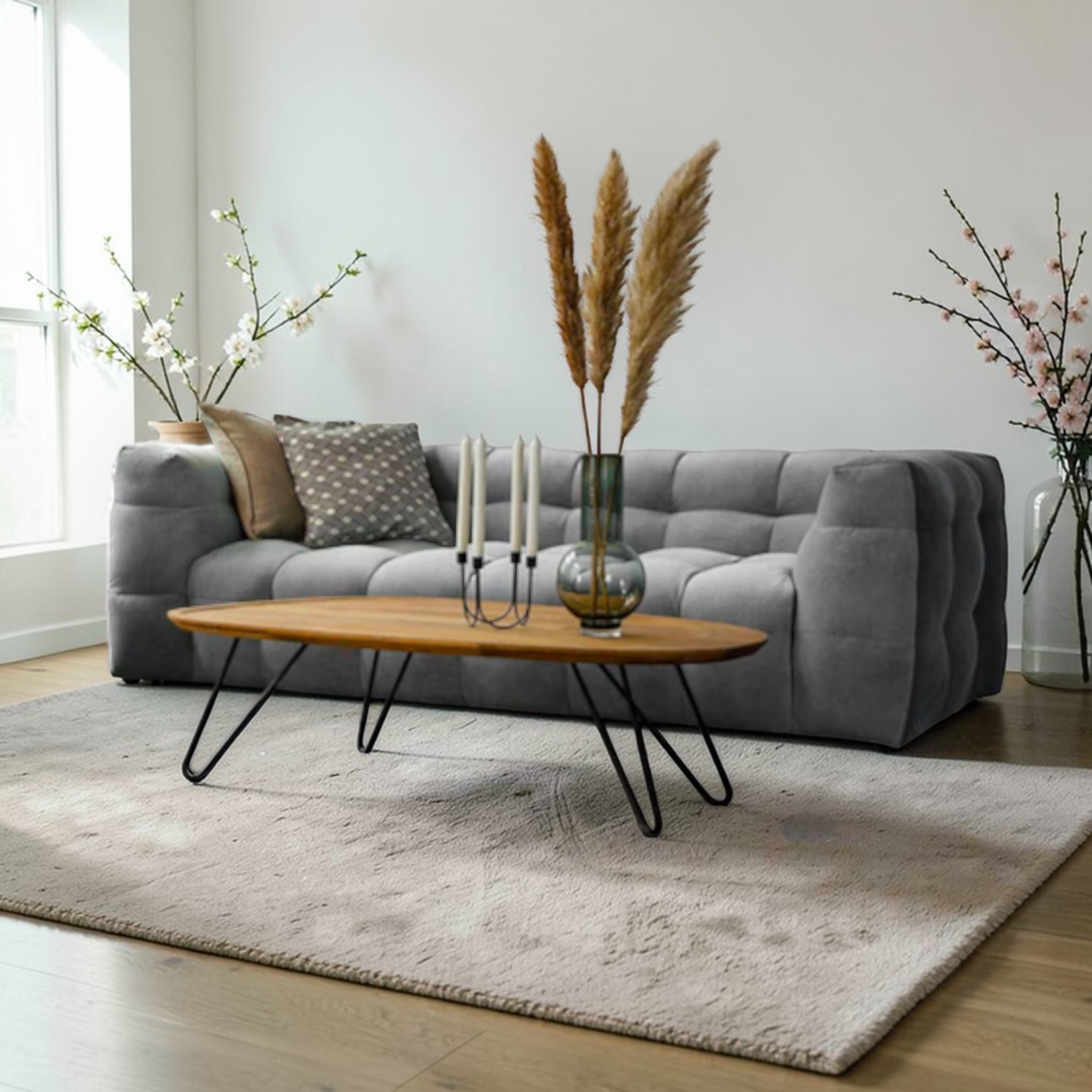 Living room with a gray sofa, wooden coffee table, and decorative elements.
