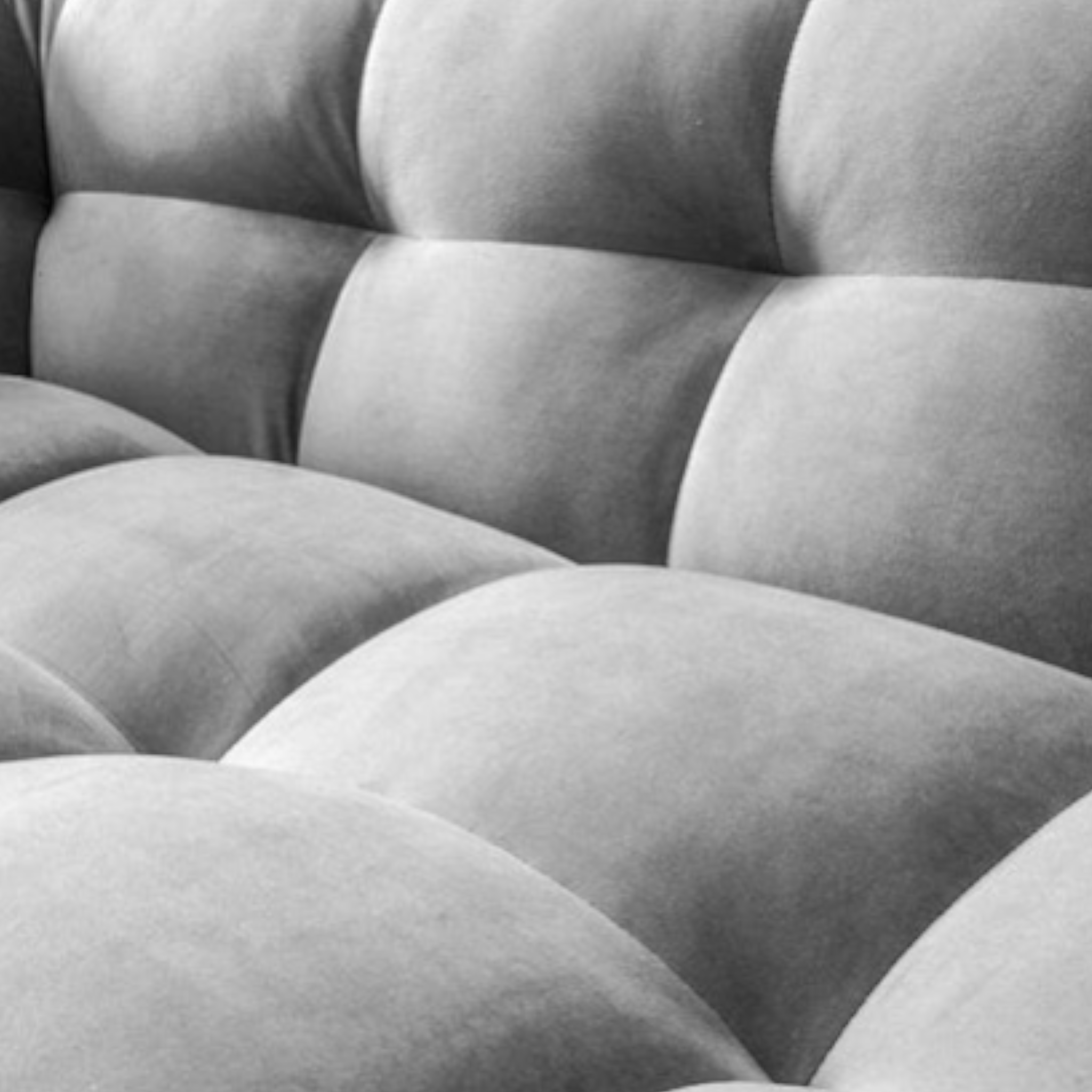 Close-up of a gray tufted cushion