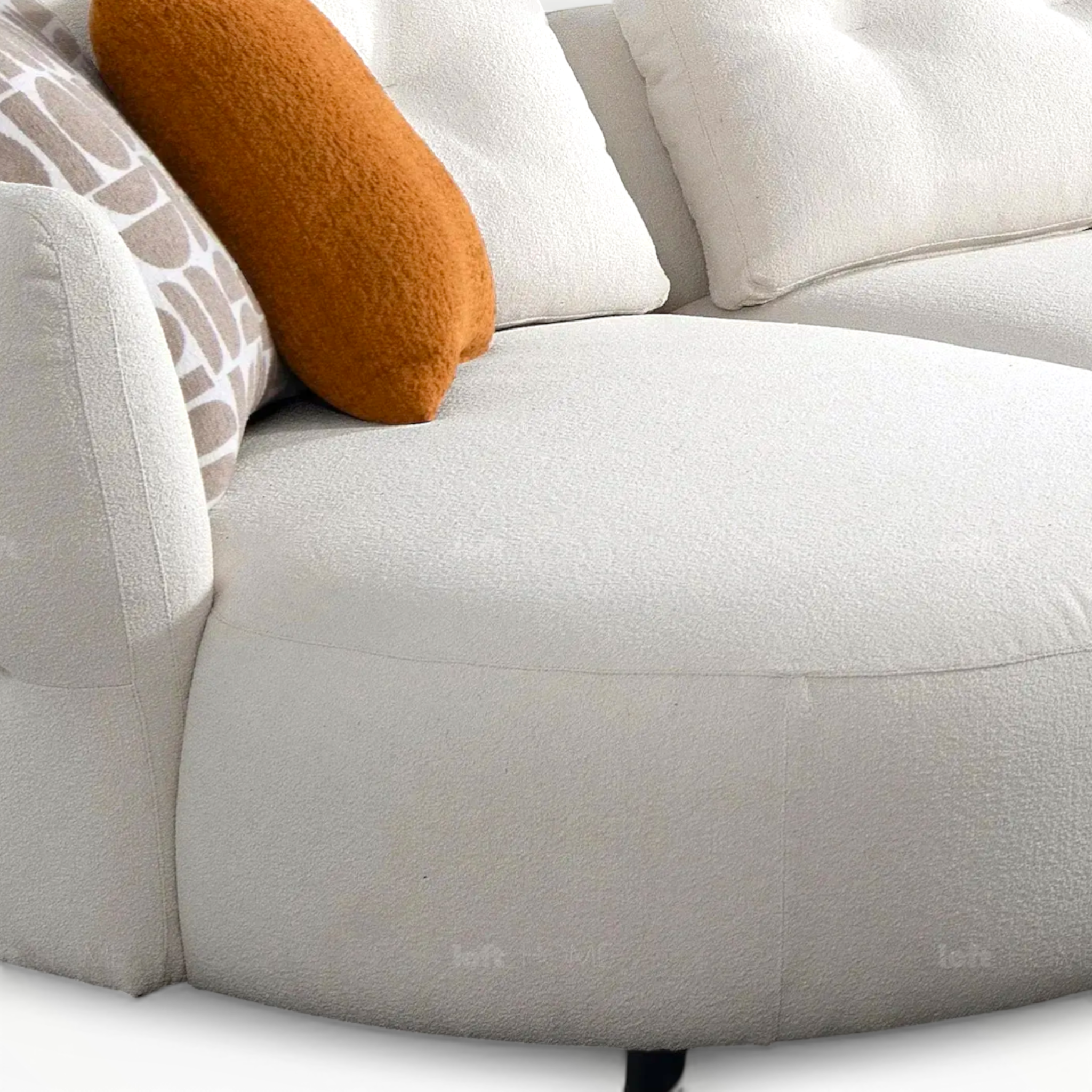 Close-up of a light gray sofa with decorative pillows on a white background