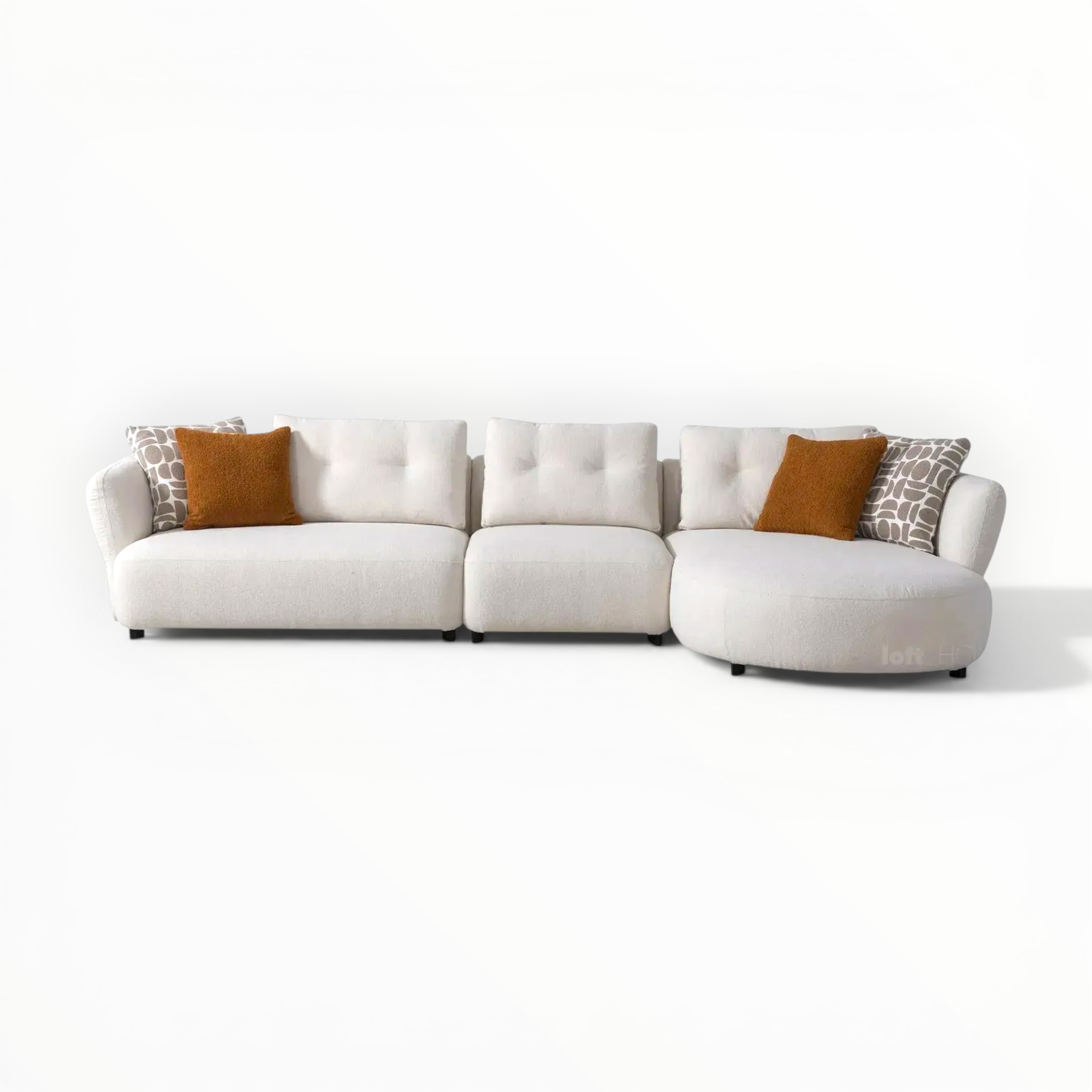 White sectional sofa with patterned and solid color cushions on a white background