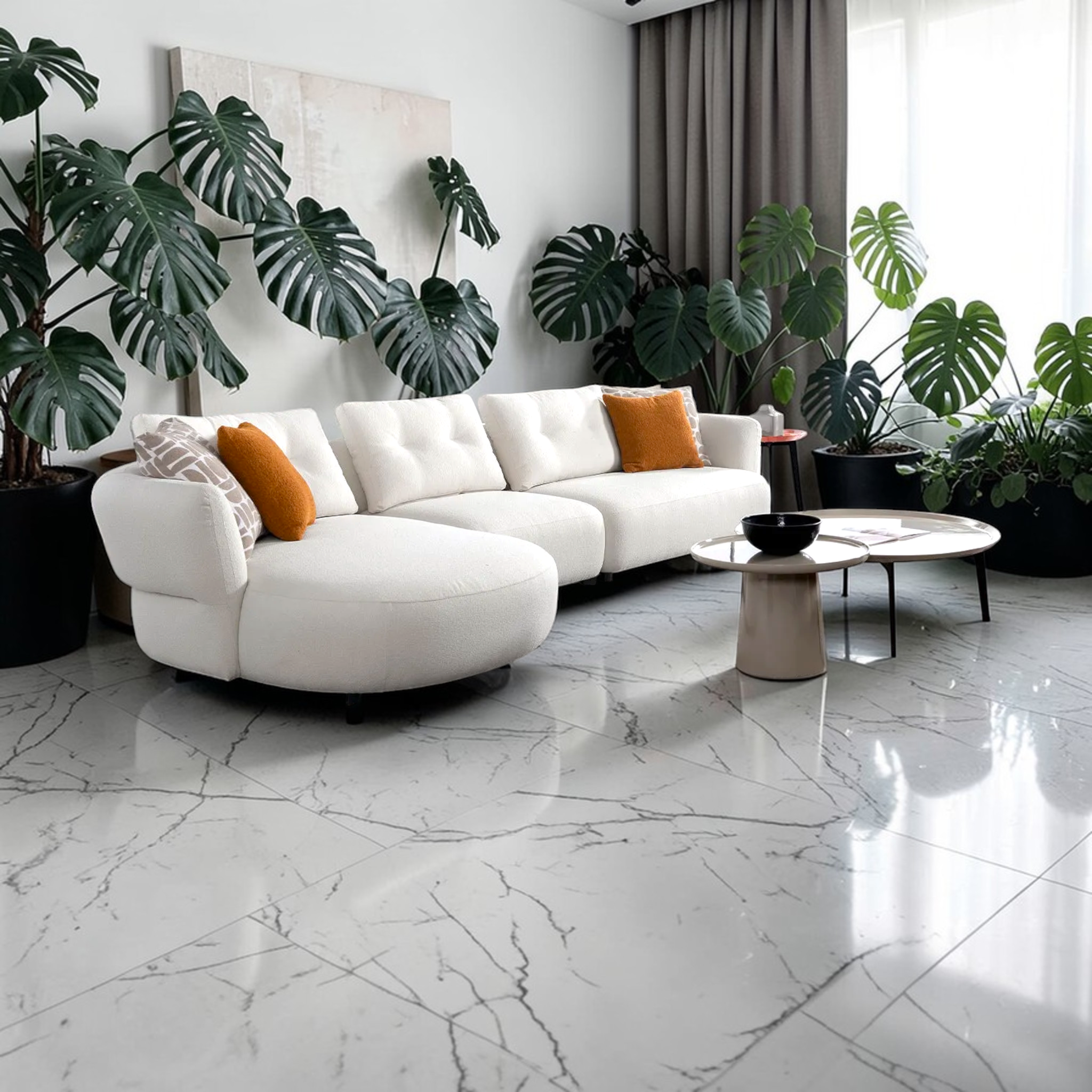 Modern living room with white sectional sofa, decorative pillows, and potted plants.