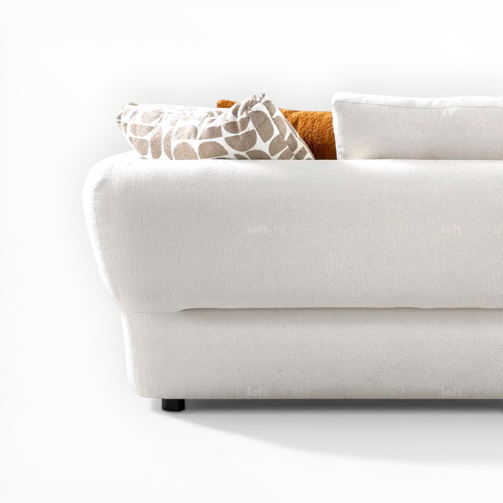 White sofa with patterned cushions on a white background