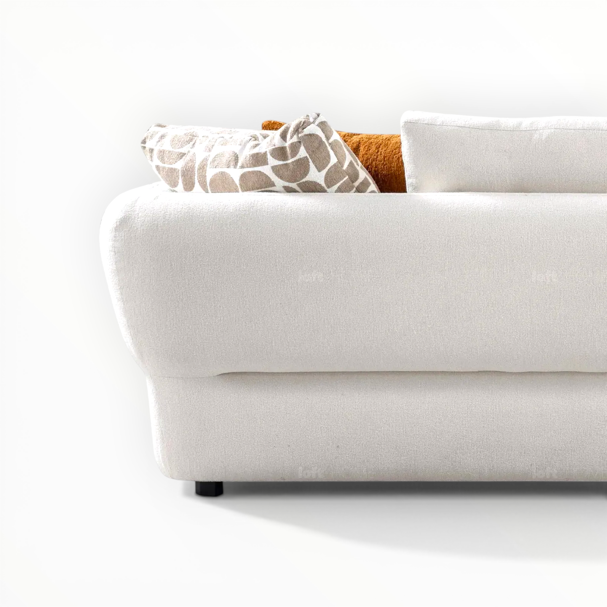 White sofa with patterned cushions on a white background