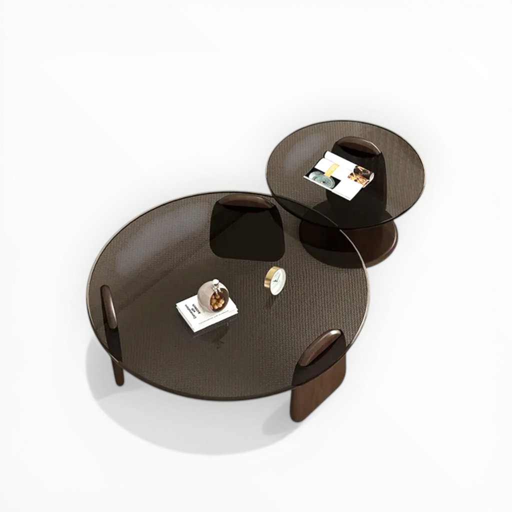 Modern round coffee table with two additional trays on a white background