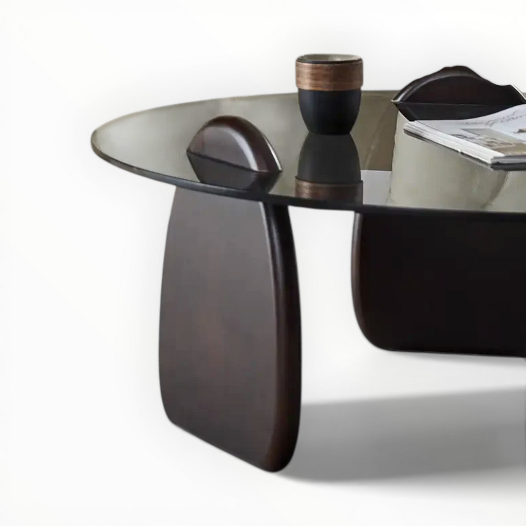 Modern glass coffee table with a dark wood base on a white background