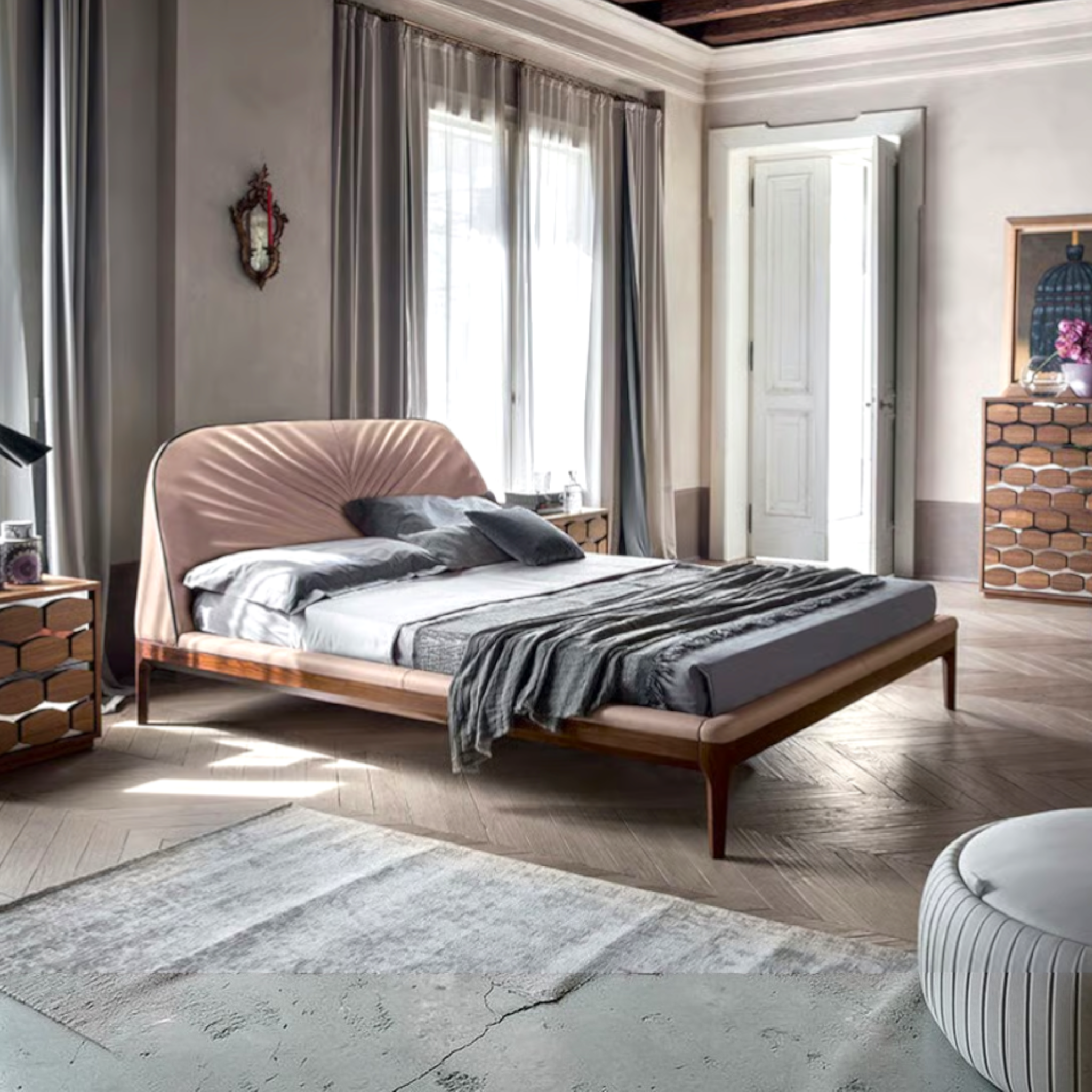 Modern bedroom with a wooden bed, gray bedding, and large windows.
