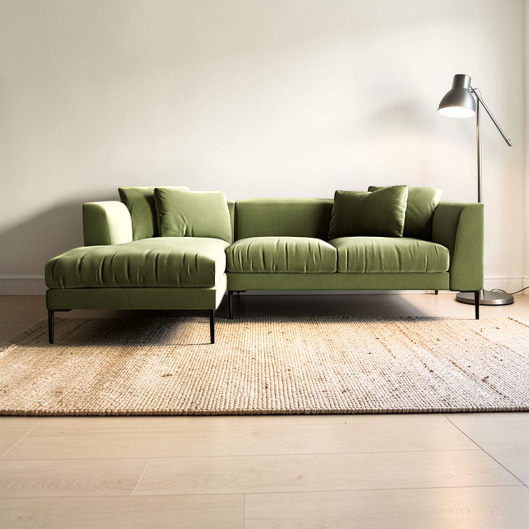 Green sectional sofa in a living room with a lamp and rug.