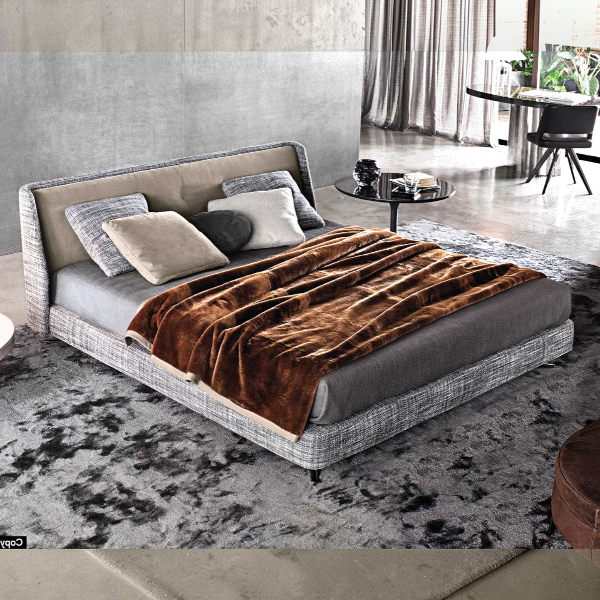Modern bedroom with a gray upholstered bed and brown blanket