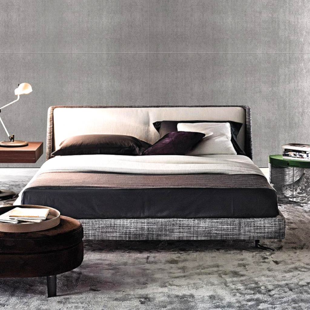 Modern bedroom with a bed, nightstands, and a lamp against a gray wall.