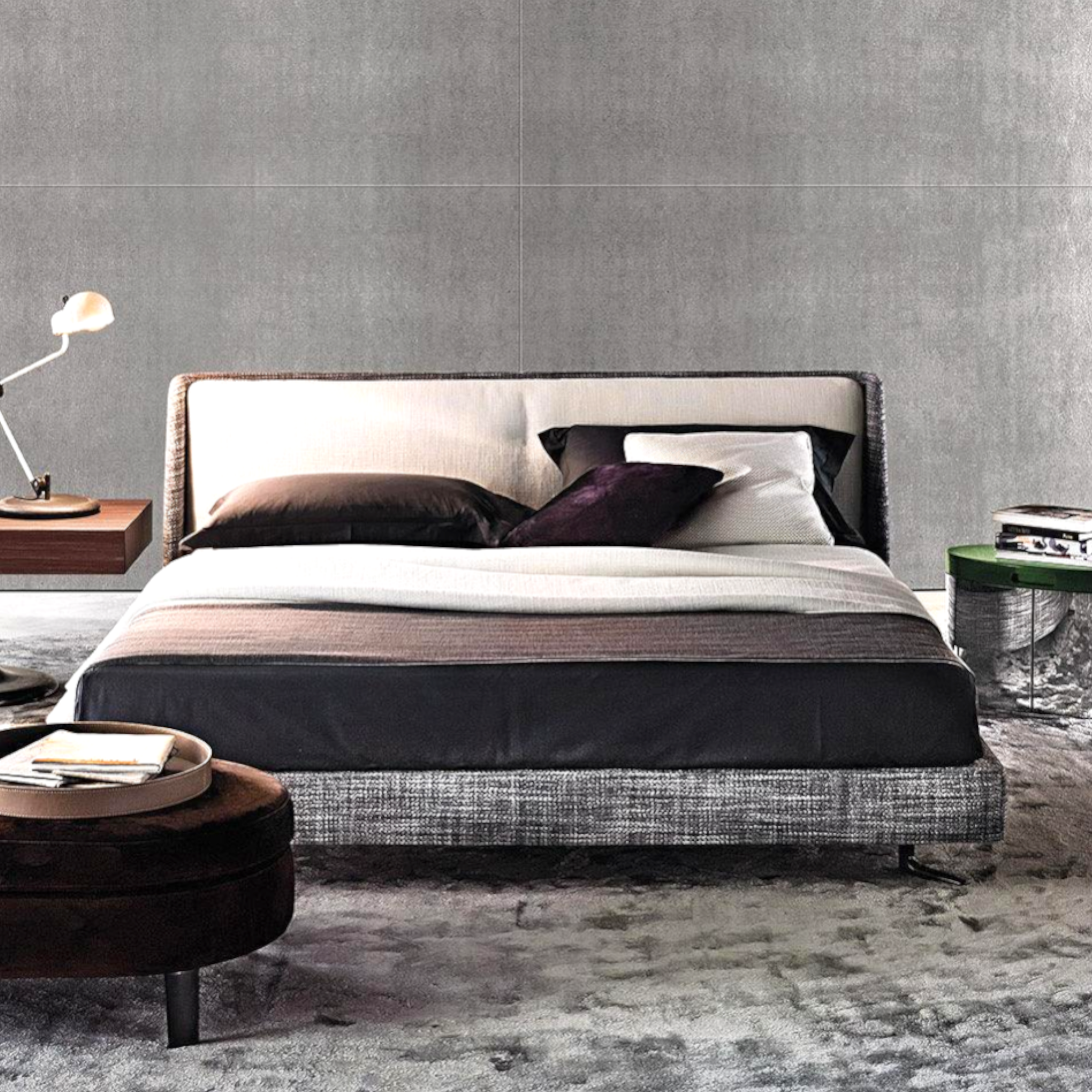 Modern bedroom with a bed, nightstands, and a lamp against a gray wall.