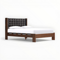 Wooden bed frame with tufted headboard on a white background