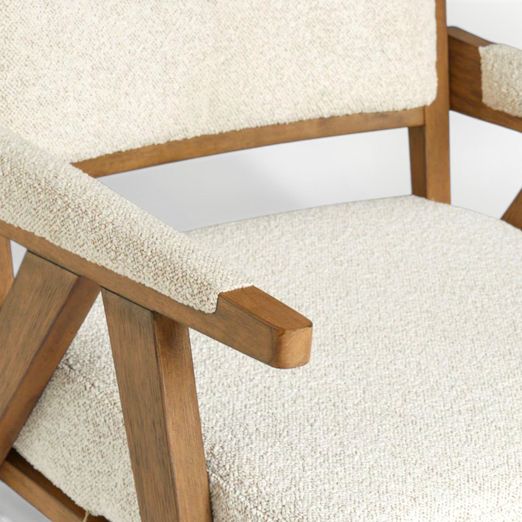 Wooden chair with beige cushioned seat and backrest on a white background