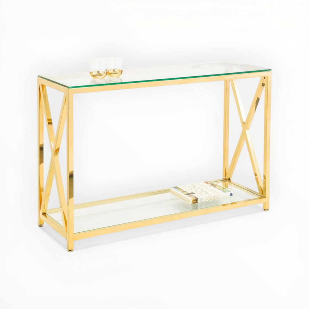 Gold console table with glass top and shelf on a white background
