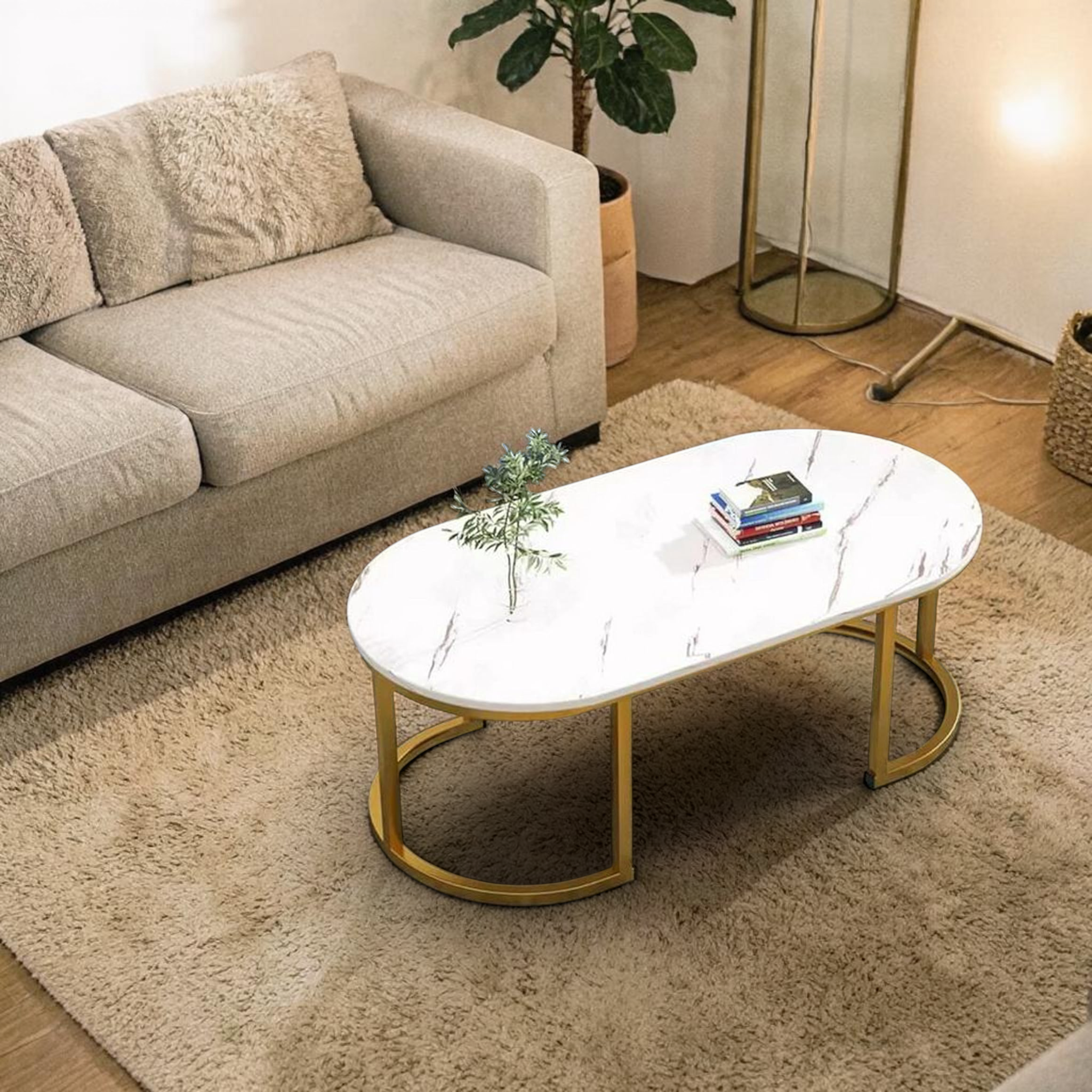 Coffee table with marble top and gold base in a living room setting