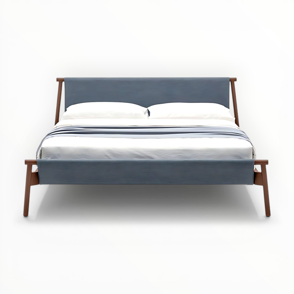 Bed with wooden frame and blue upholstered headboard on a white background