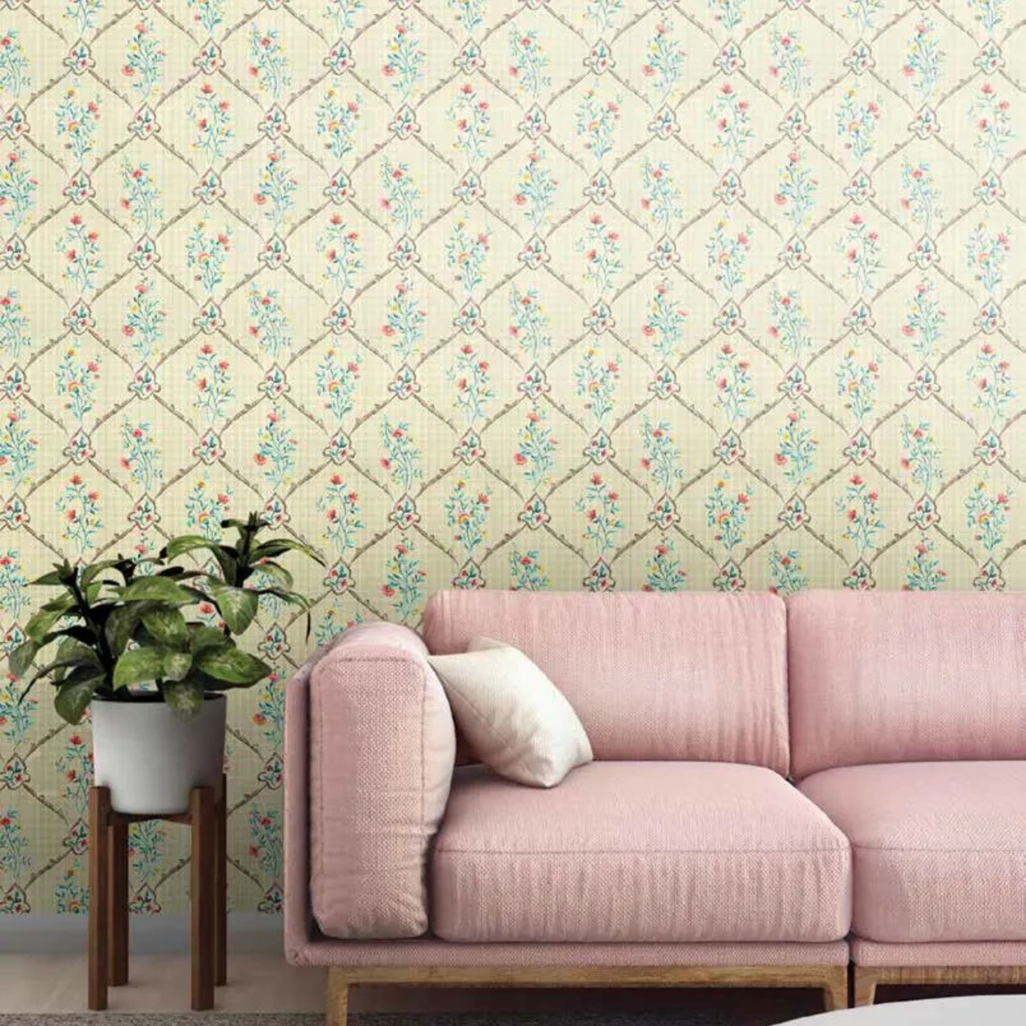 Pink sofa against a decorative wall with floral pattern