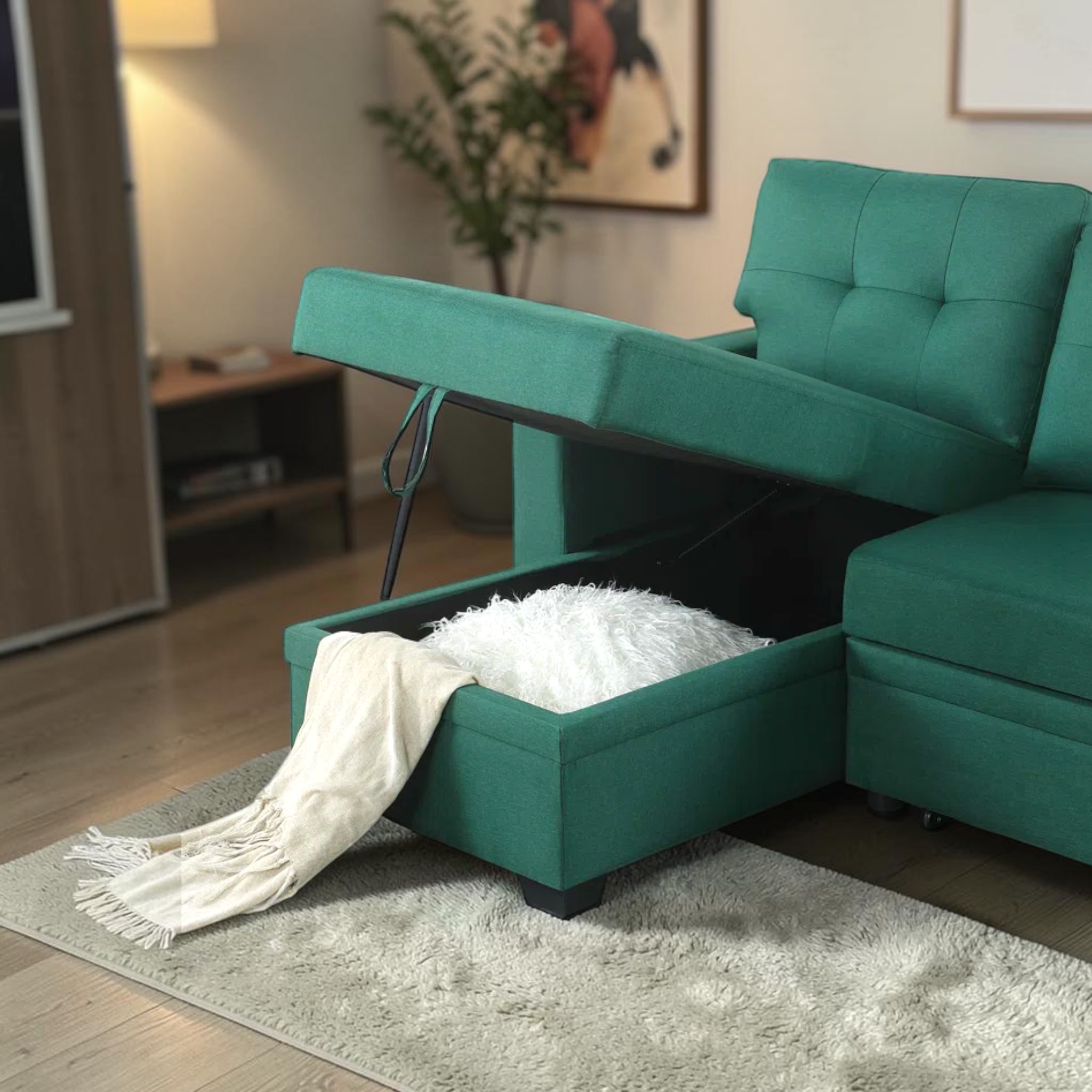 Teal sectional sofa with storage ottoman in a living room setting.