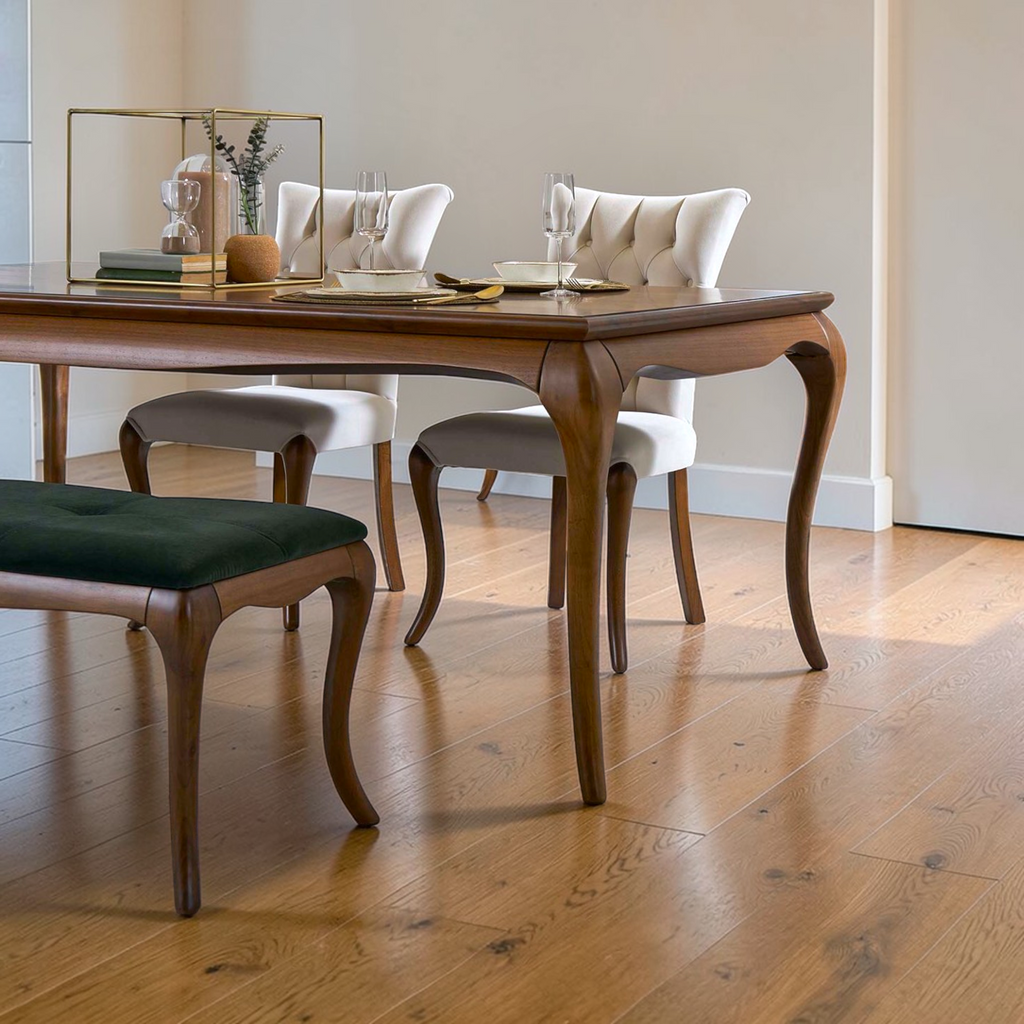 Dining room with wooden table and chairs on a wooden floor.