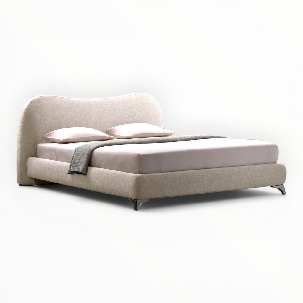 Beige bed with pillows and a blanket on a white background